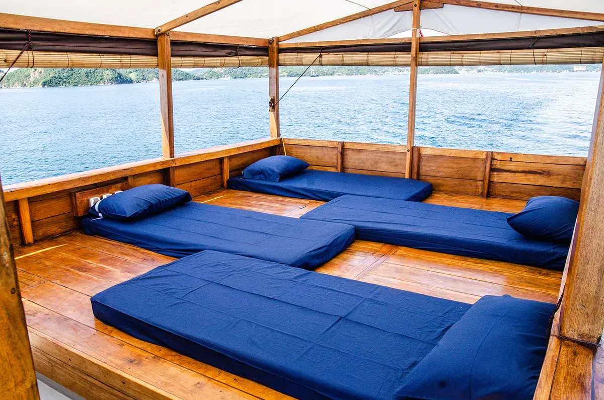 Neatly arranged sleeping mattresses on Nusantara’s covered deck